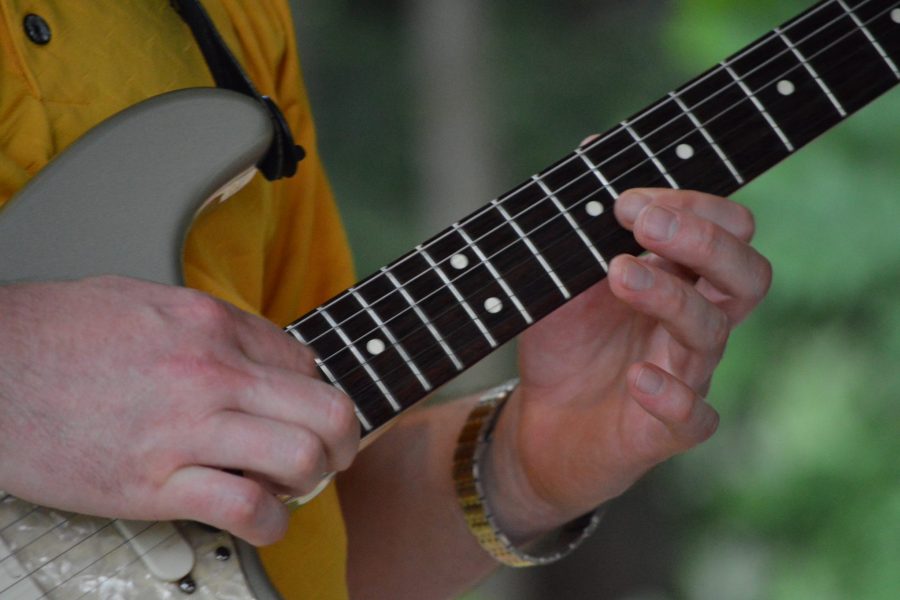 Aaron Playing electric guitar in yellow shirt